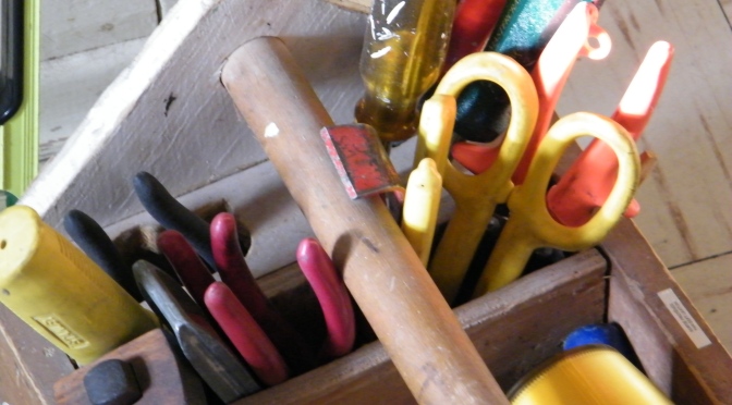 A wooden toolbox with multicoloured tools